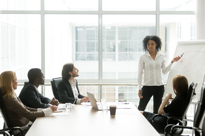 group of business professionals sitting at a conference table
